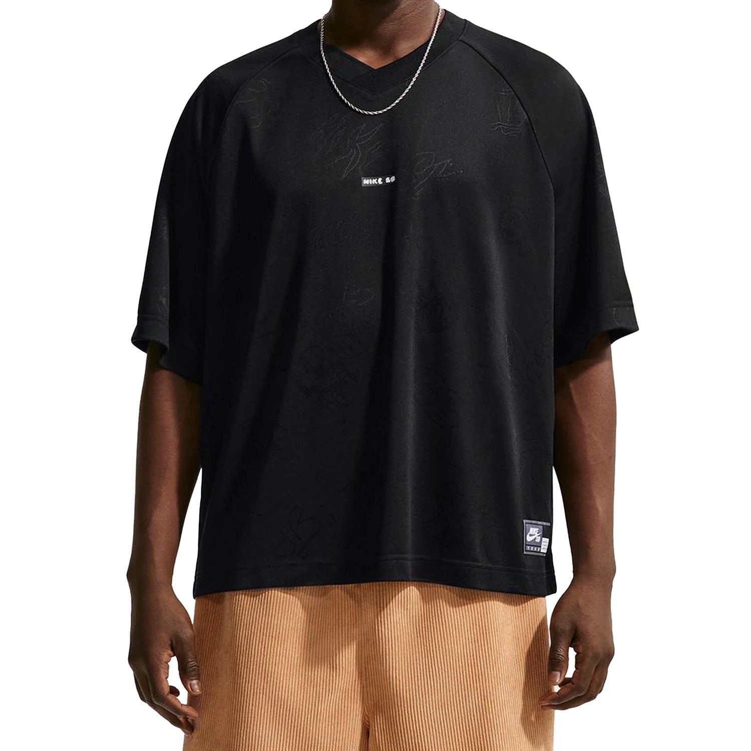 Person wearing a black Nike SB Jacquard Skate Jersey with visible branding on a white background