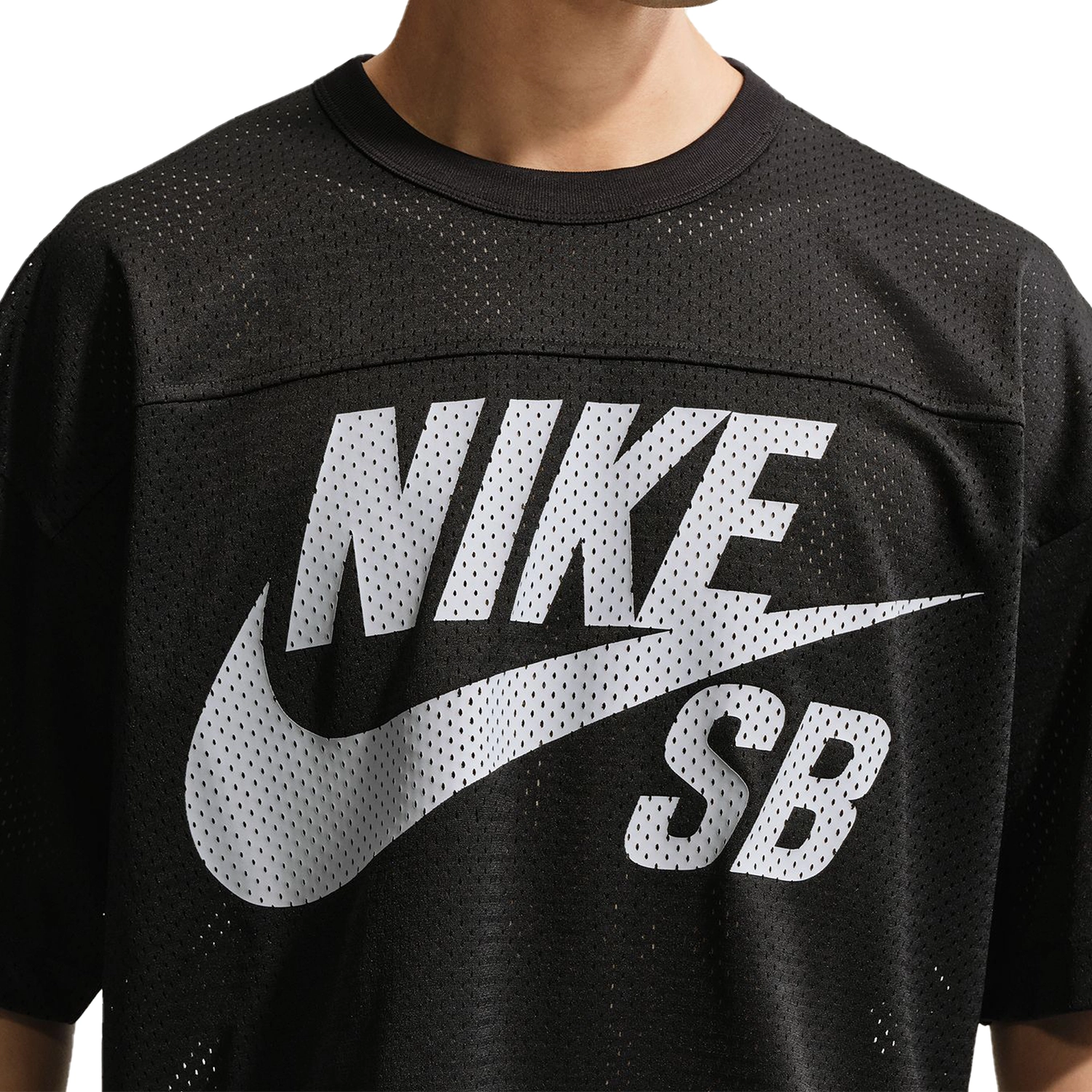 Close up of Black Nike SB GFX mesh football jersey worn by a person on a white background