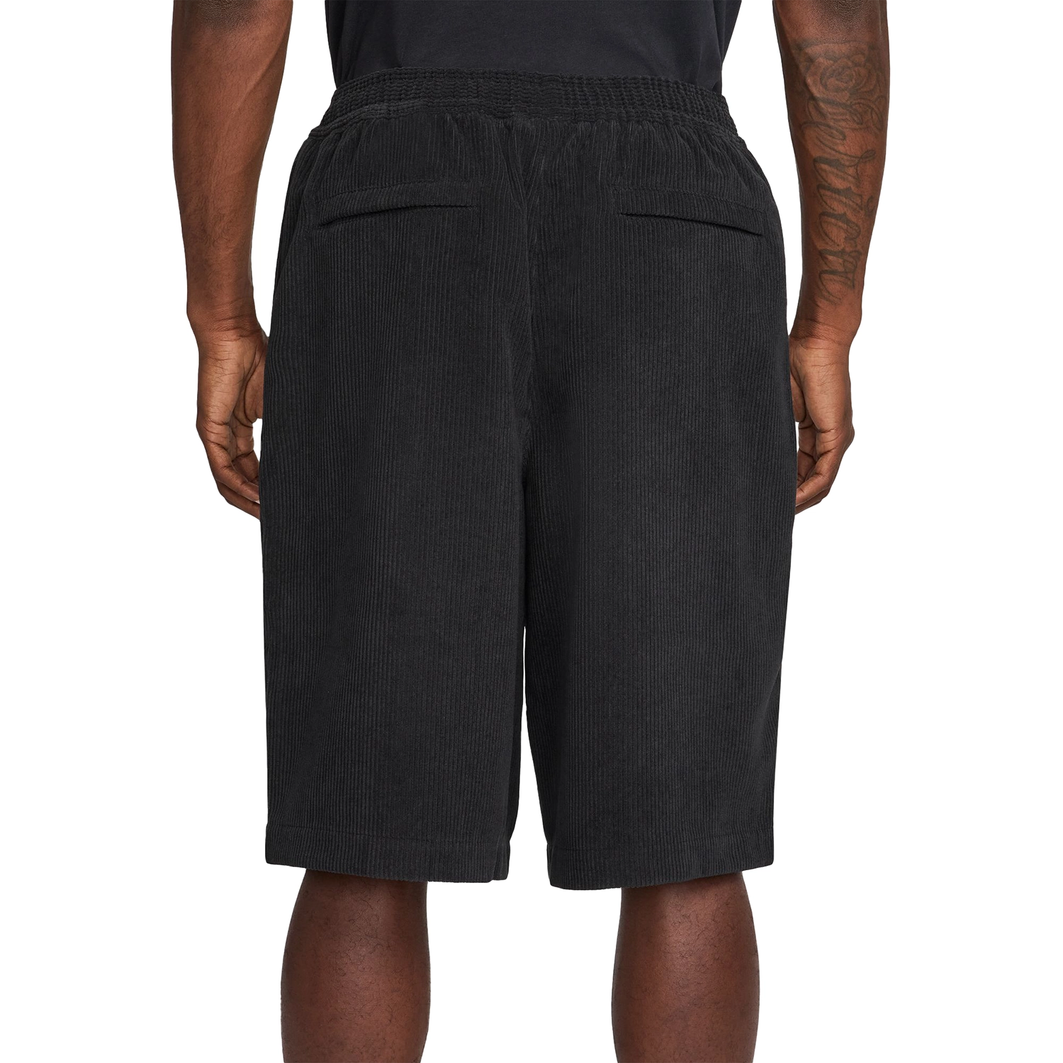Black Nike SB Skate shorts worn by a person on a white background