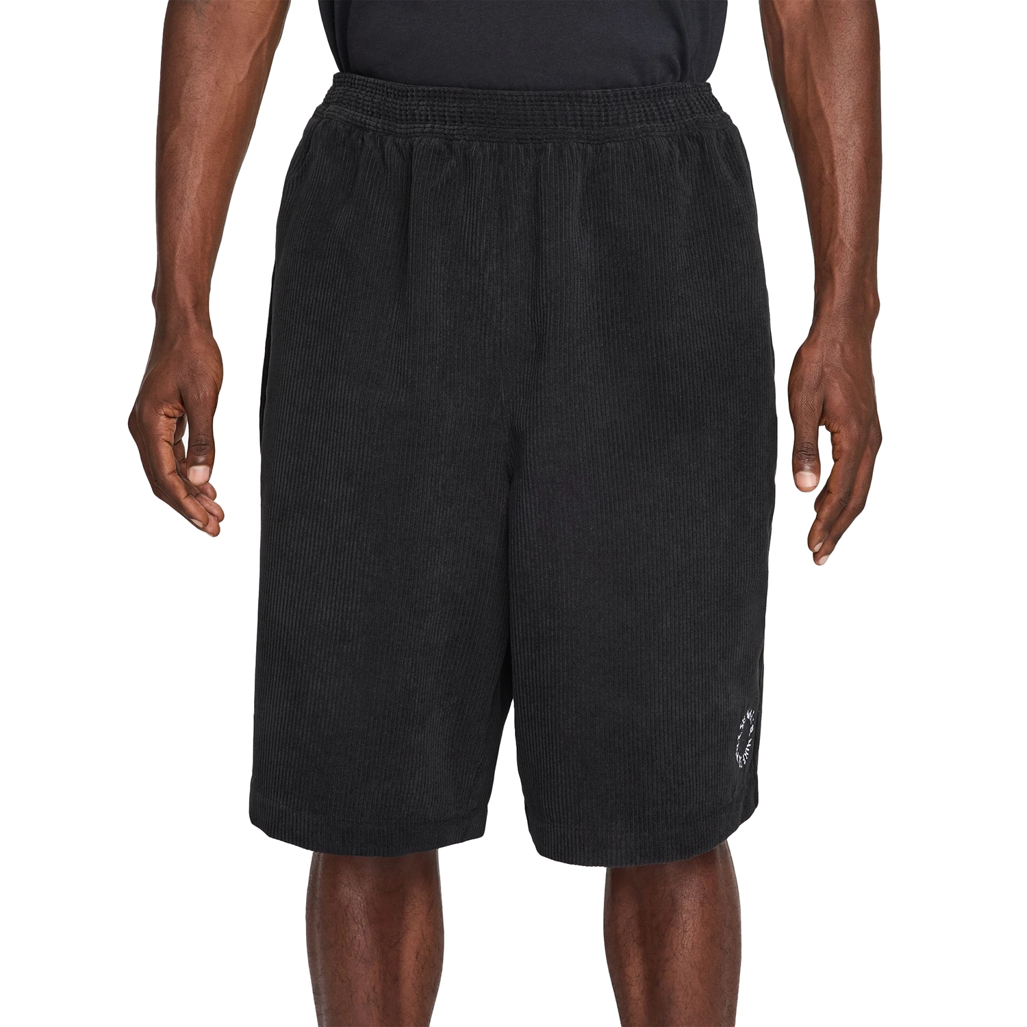 Black Nike SB Skate shorts worn by a person on a white background