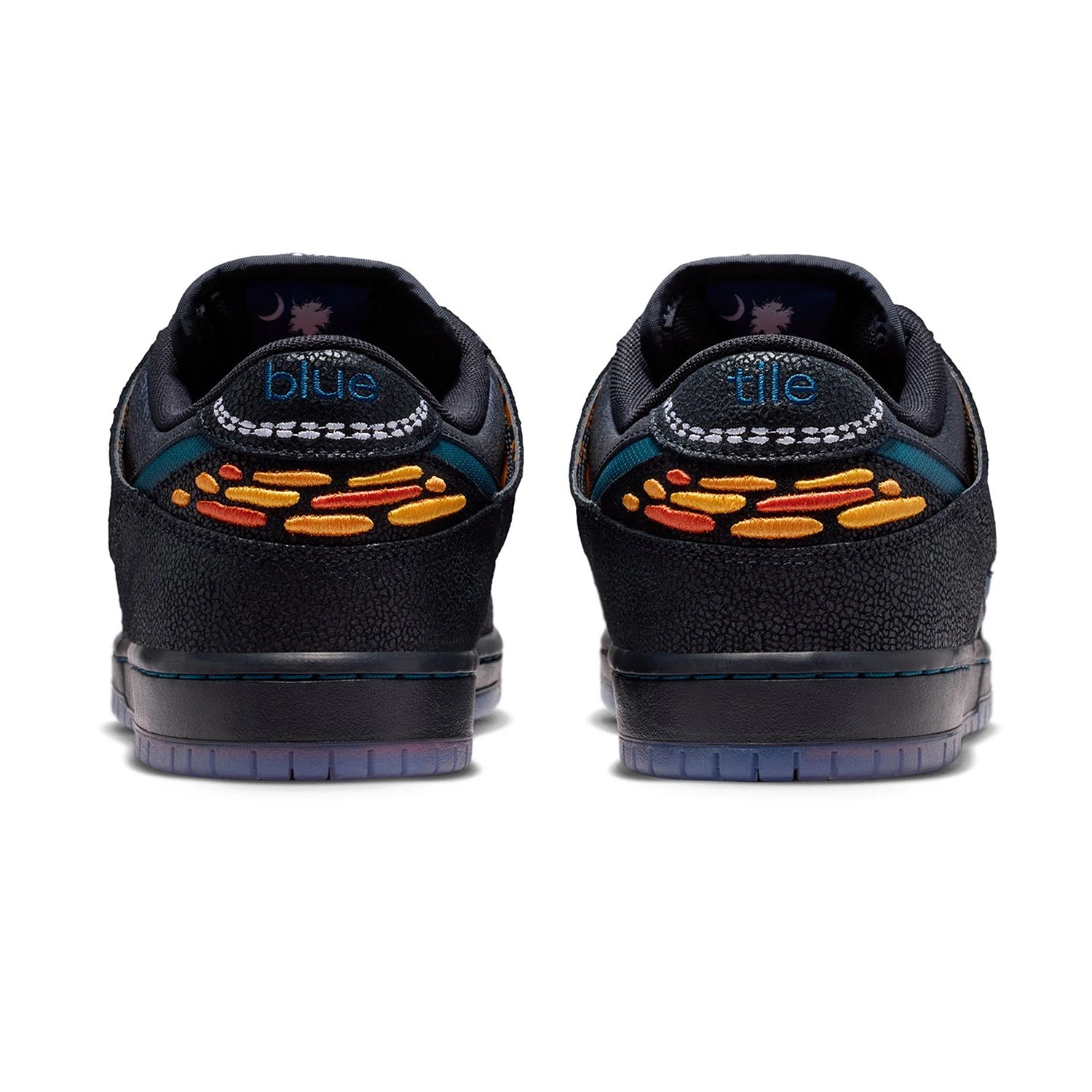 Heel bellows of a pair of Black and marina Nike SB Dunk Low Pro men's skateboarding sneakers on a white background