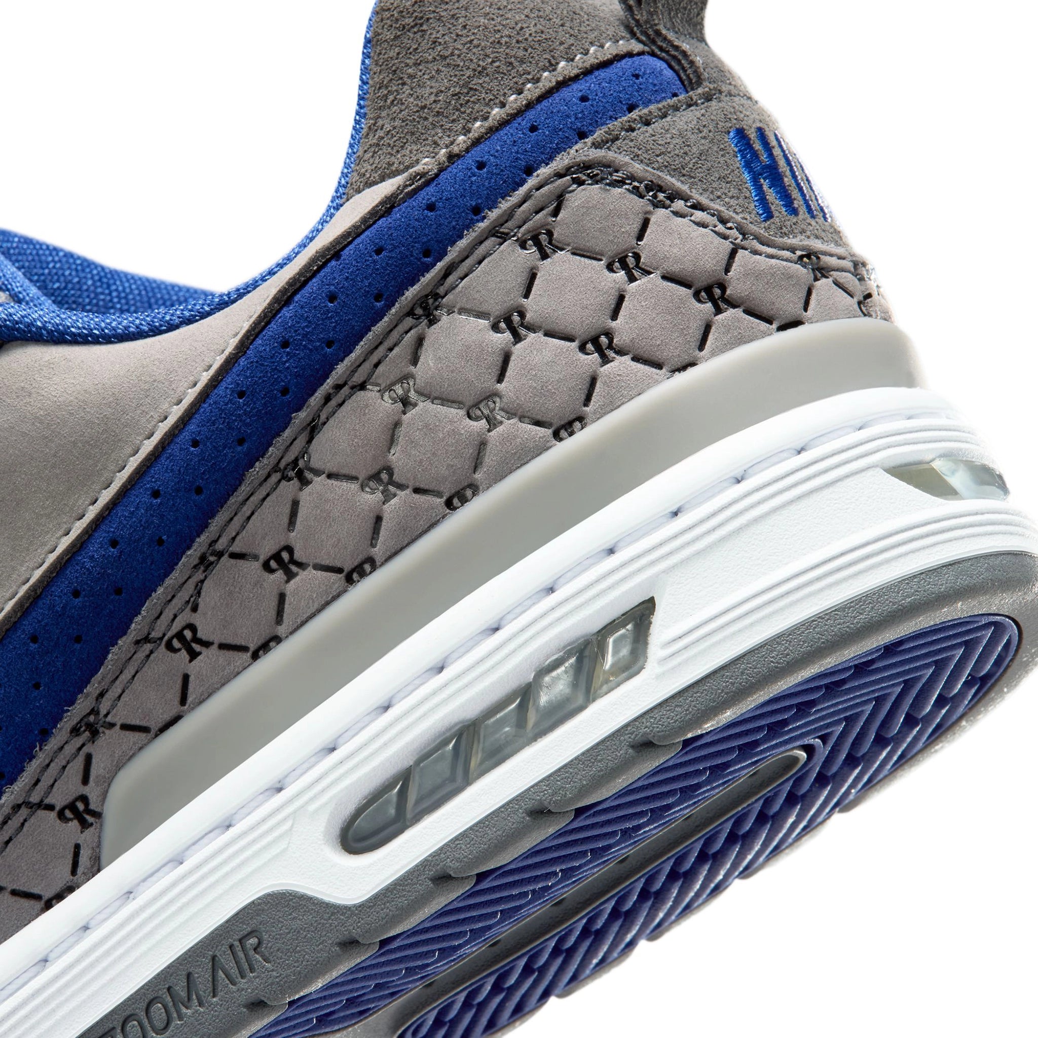Close up of Flint grey Nike SB Paul Rodriguez Zoom Air skateboard sneaker with royal navy swoosh on a white background