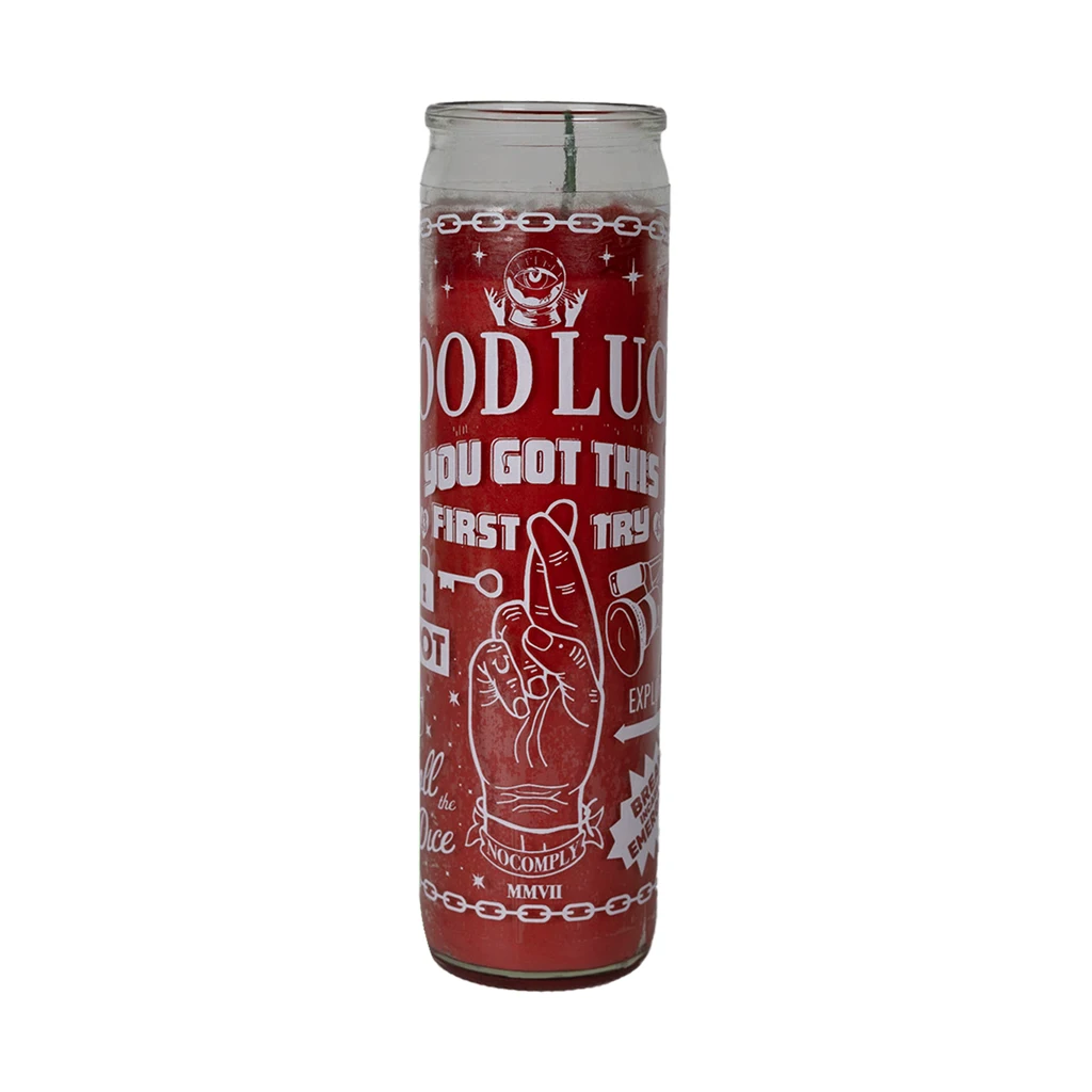 No-Comply red lucky candle with white design on a white background