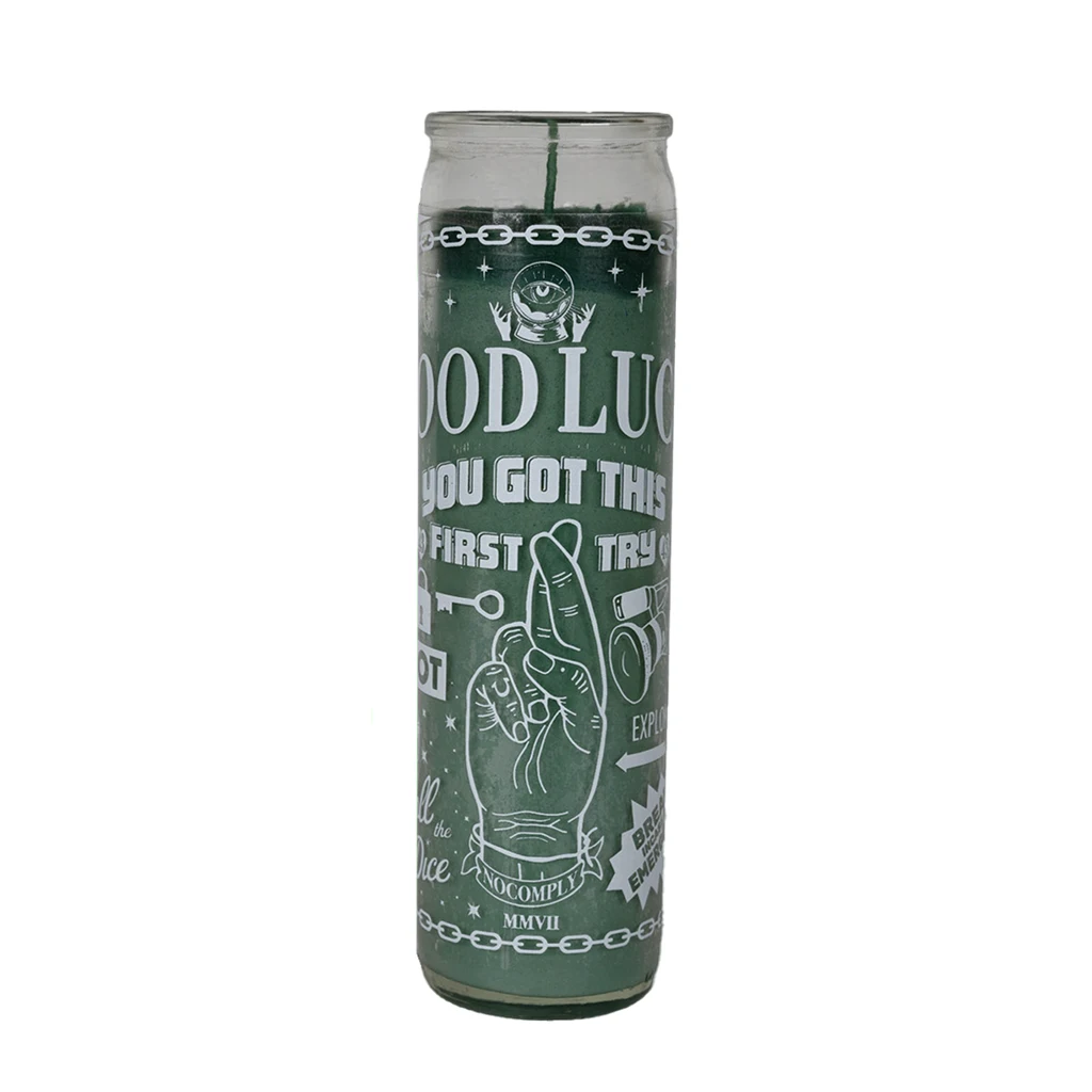 No-Comply green lucky candle with white design on a white background