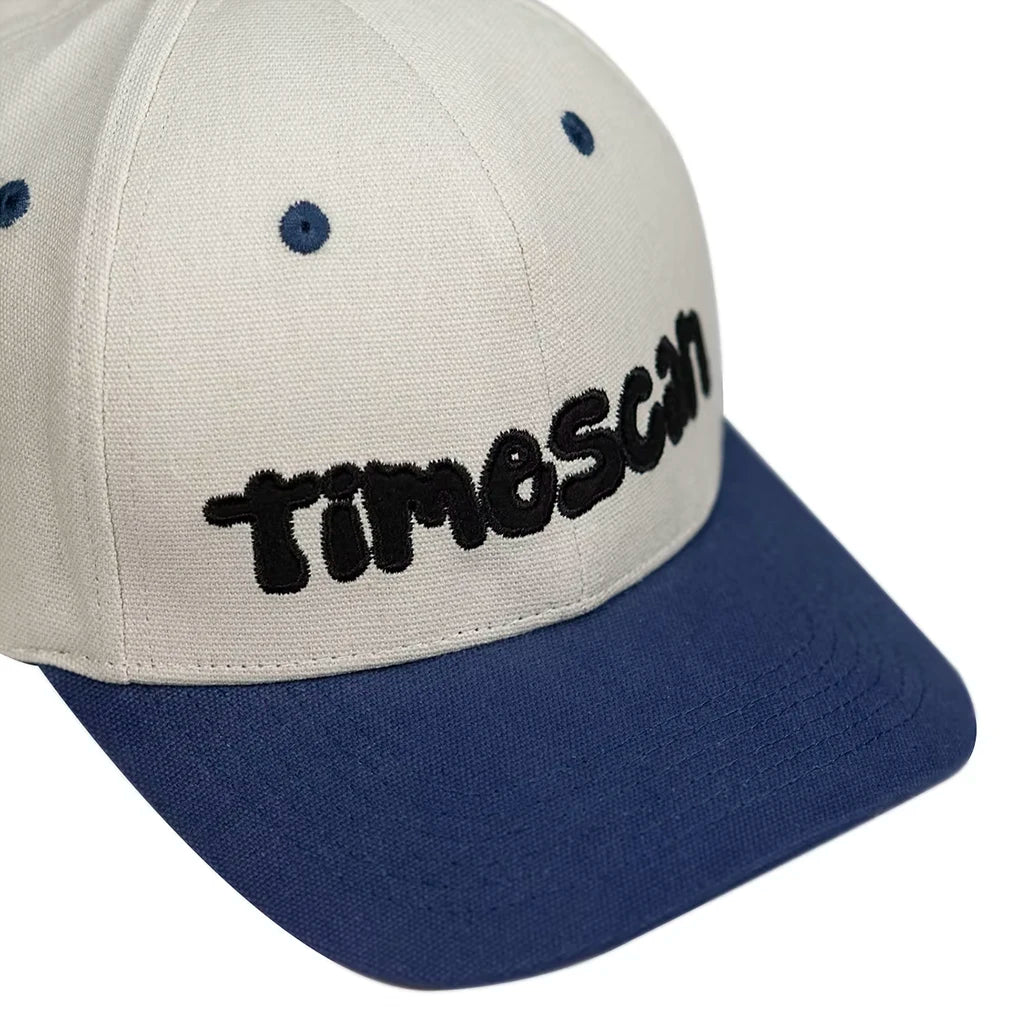 Beige and navy Time Scan Twister cap with 'TIMESCAN' logo on a white background