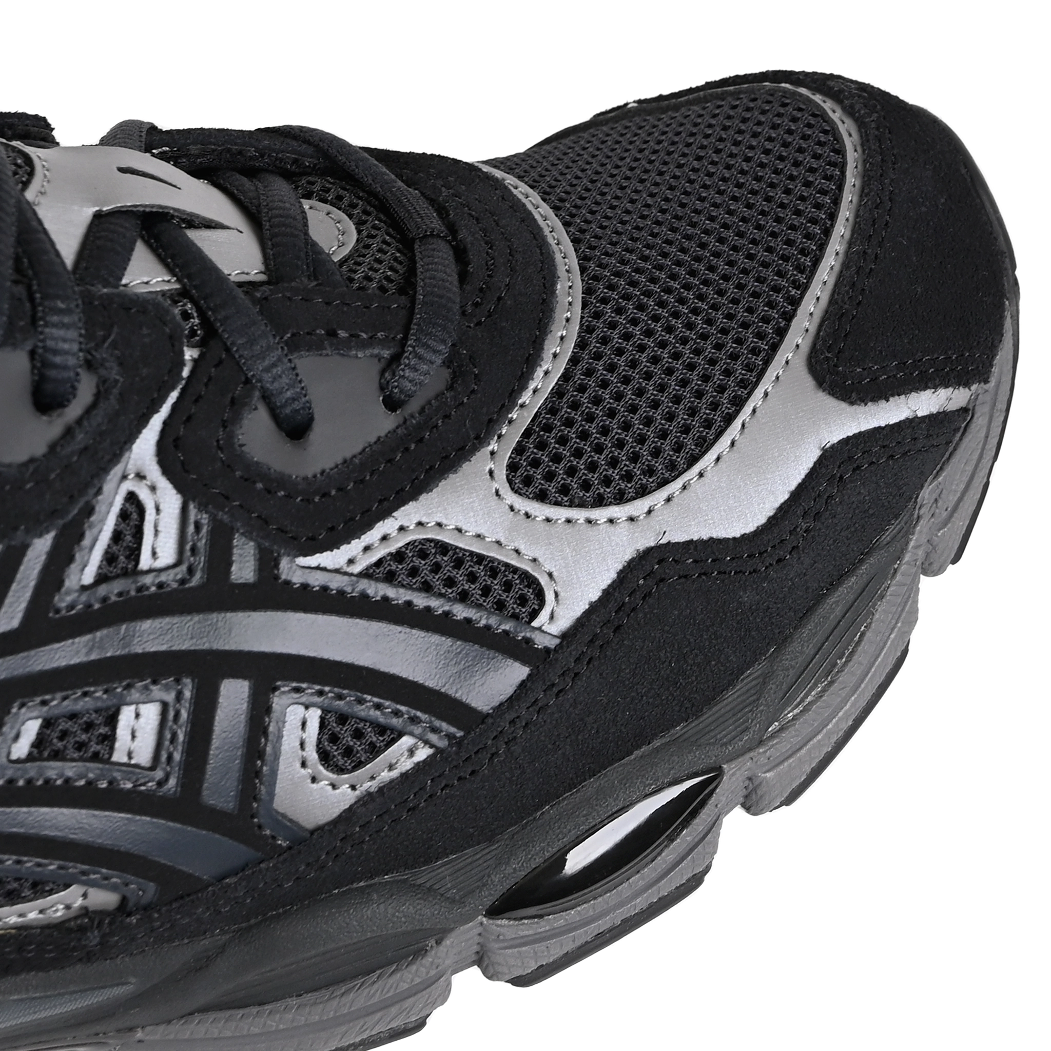 Toe box of Graphite grey and black Asics Sportstyle GEL-NYC mens lifestyle sneaker with 'Onitsuka' branding on a white background