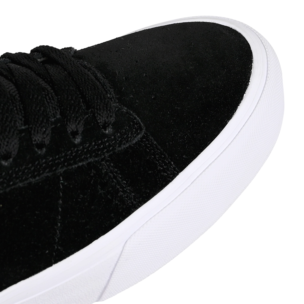 Close-up of an Emerica Skateboarding black sneaker with white sole on a white background