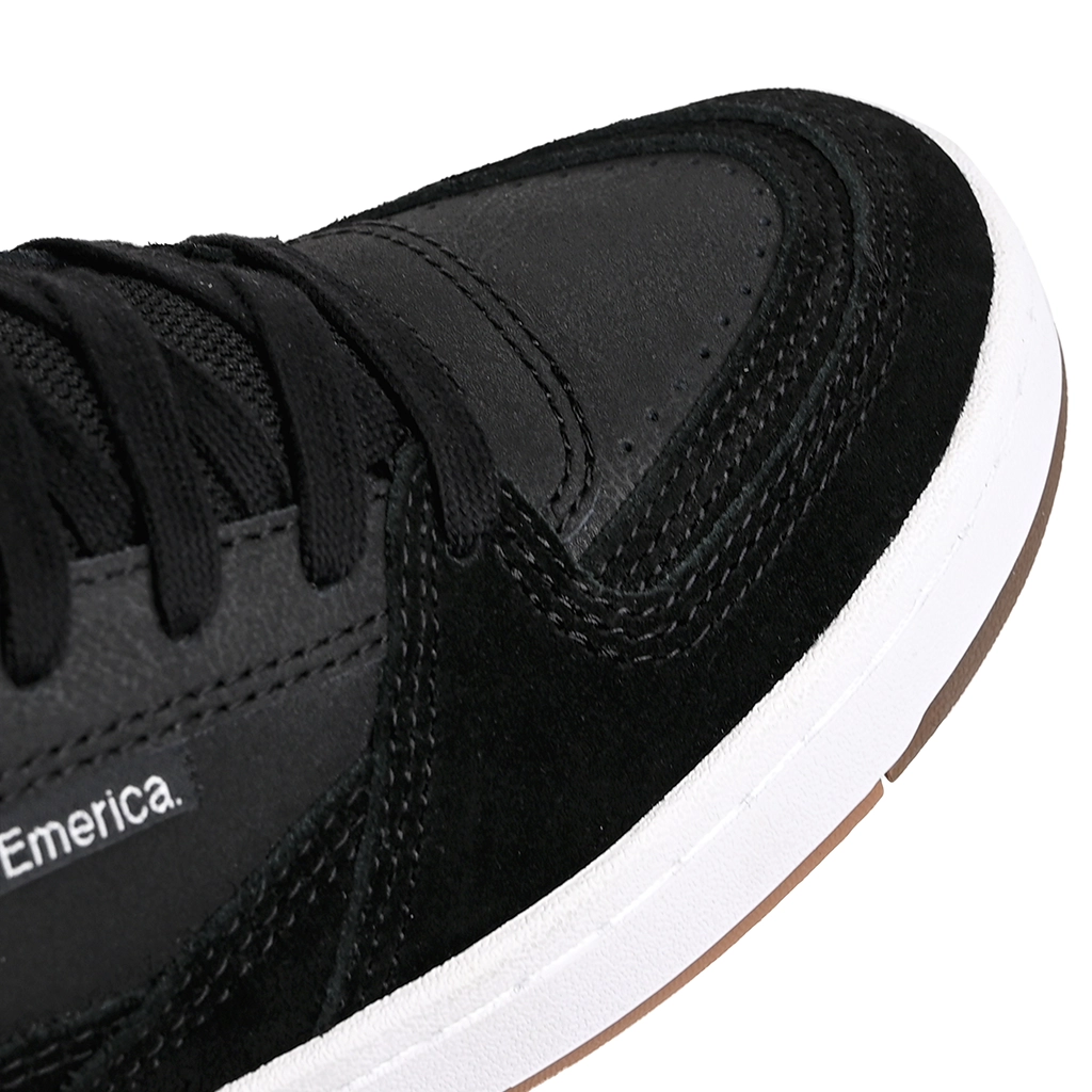 Close up of Black Emerica Skateboarding Mute sneaker with white sole on a white background