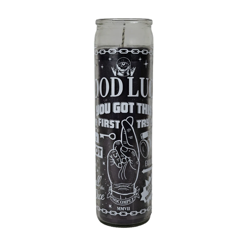 No-Comply black lucky candle with white design on a white background