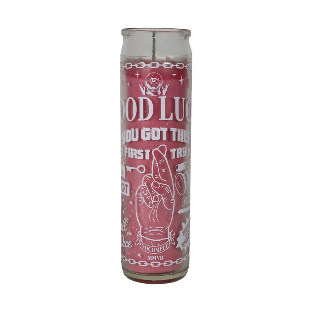 No-Comply pink lucky candle with white design on a white background