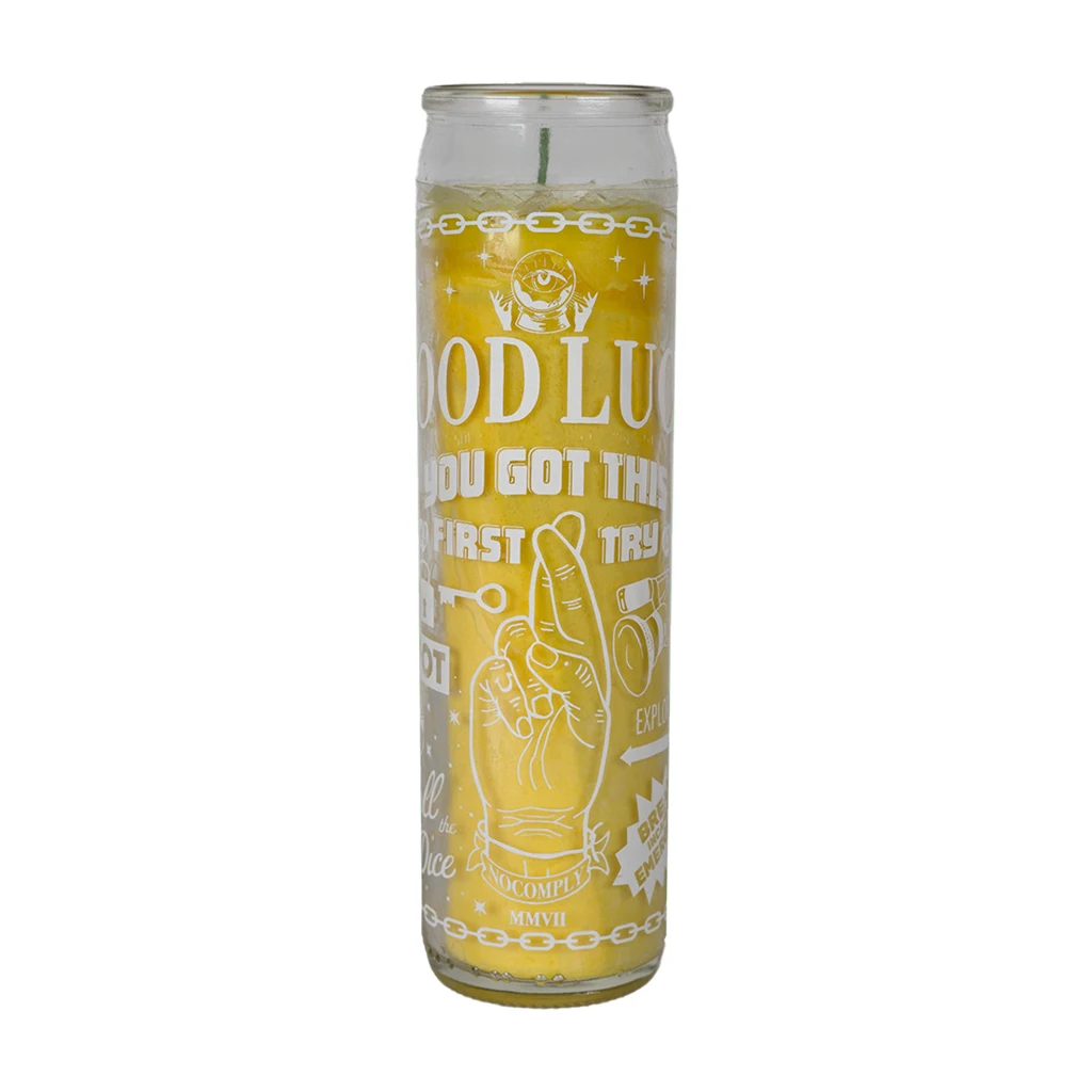No-Comply yellow lucky candle with white design on a white background