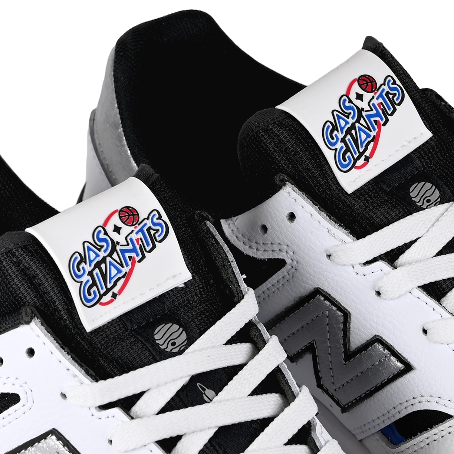 Tongue tag close up of white blue black New Balance Numeric x Gas Giants NM306 Cup Jamie Foy pro model men's skateboard sneakers on a white background