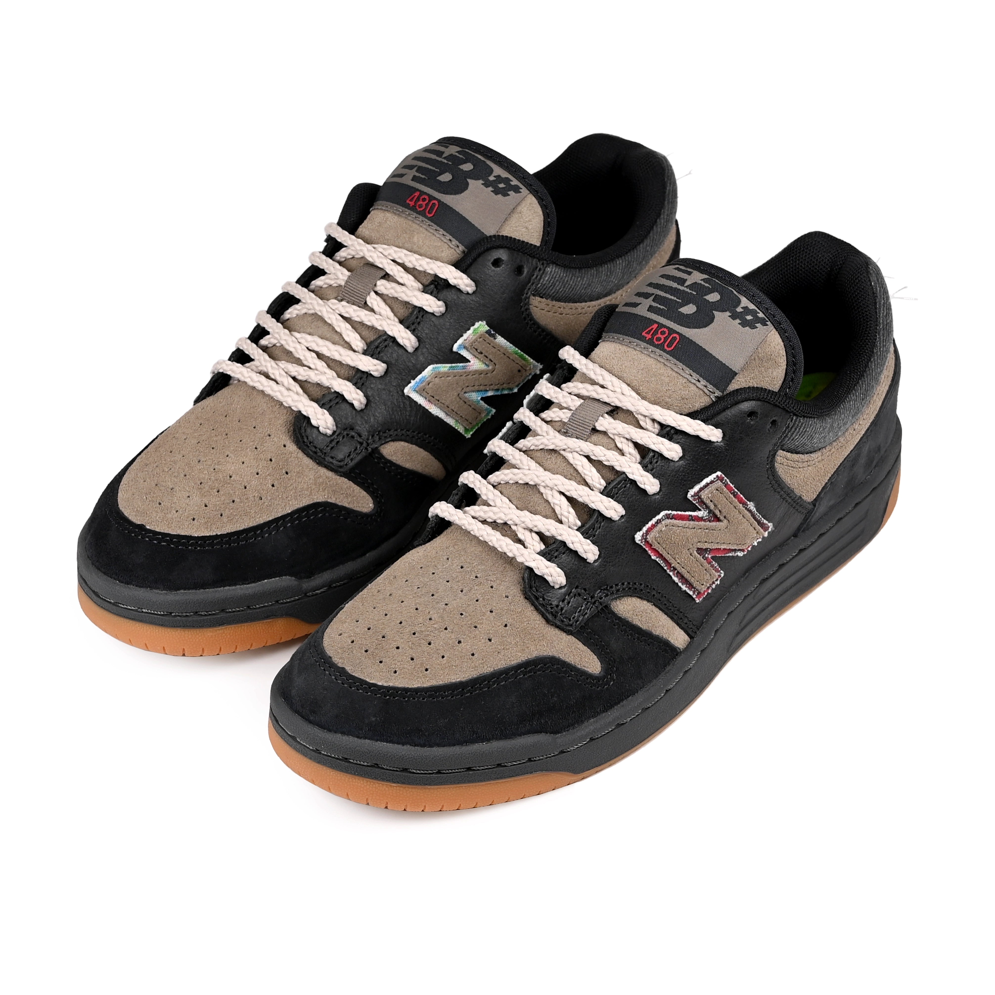 A pair of Black and arid stone New Balance Numeric x No-Comply NM480 skateboard sneakers with alternate laces on a white background