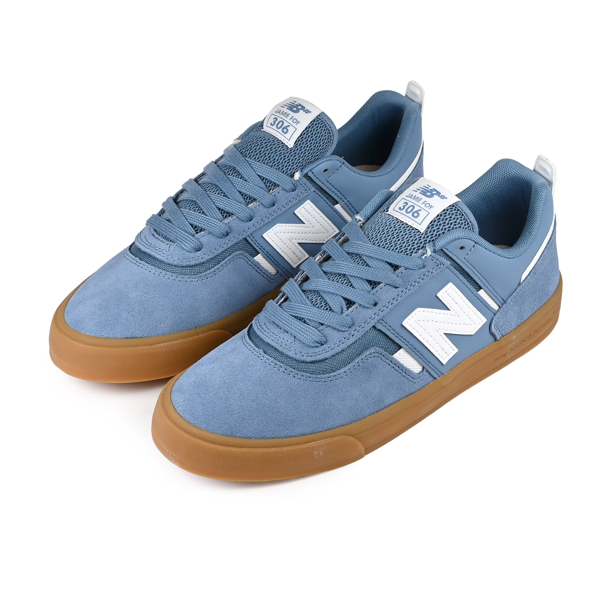 A pair of Heron blue New Balance NM306 Jamie Foy pro model skateboard sneakers with gum sole and white branding on a white background