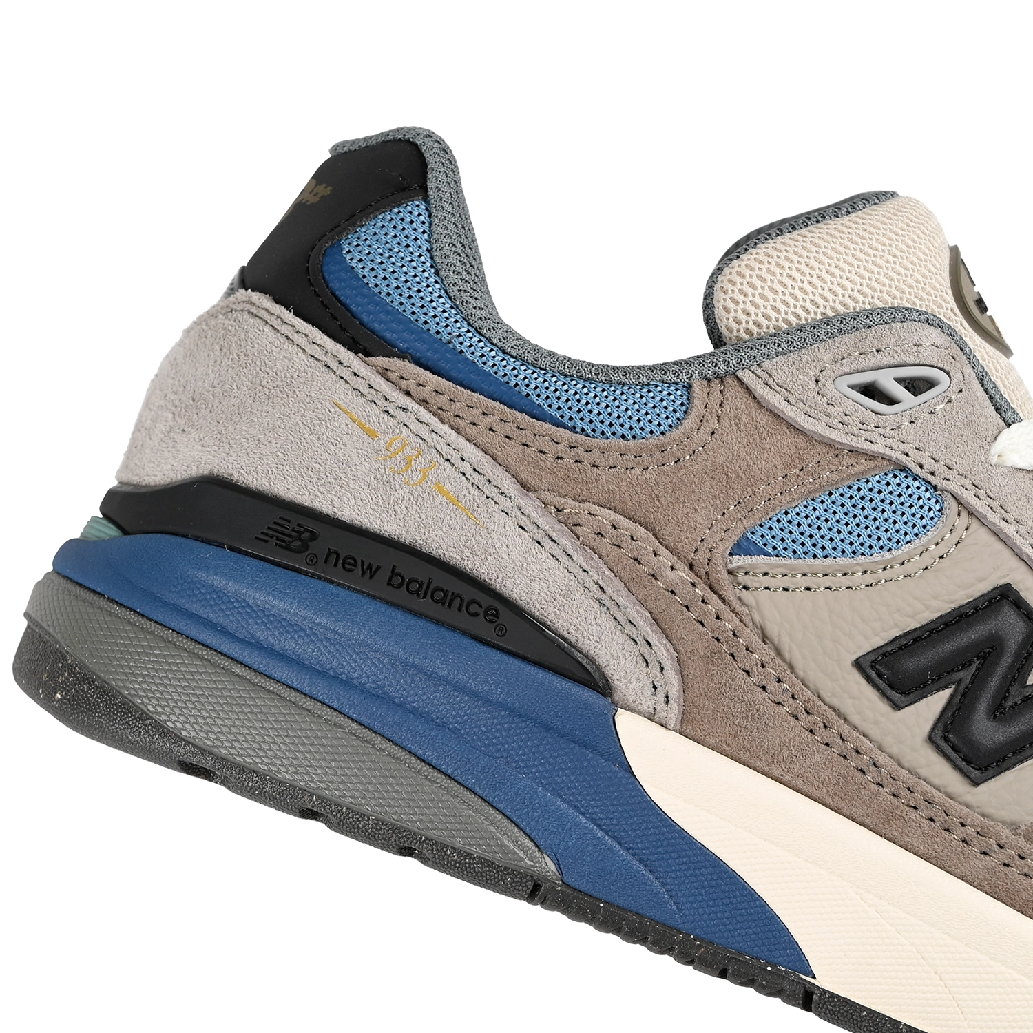 Close up of New Balance Andrew Reynolds NM933 sneaker in gray and blue with New Balance logo on a white background