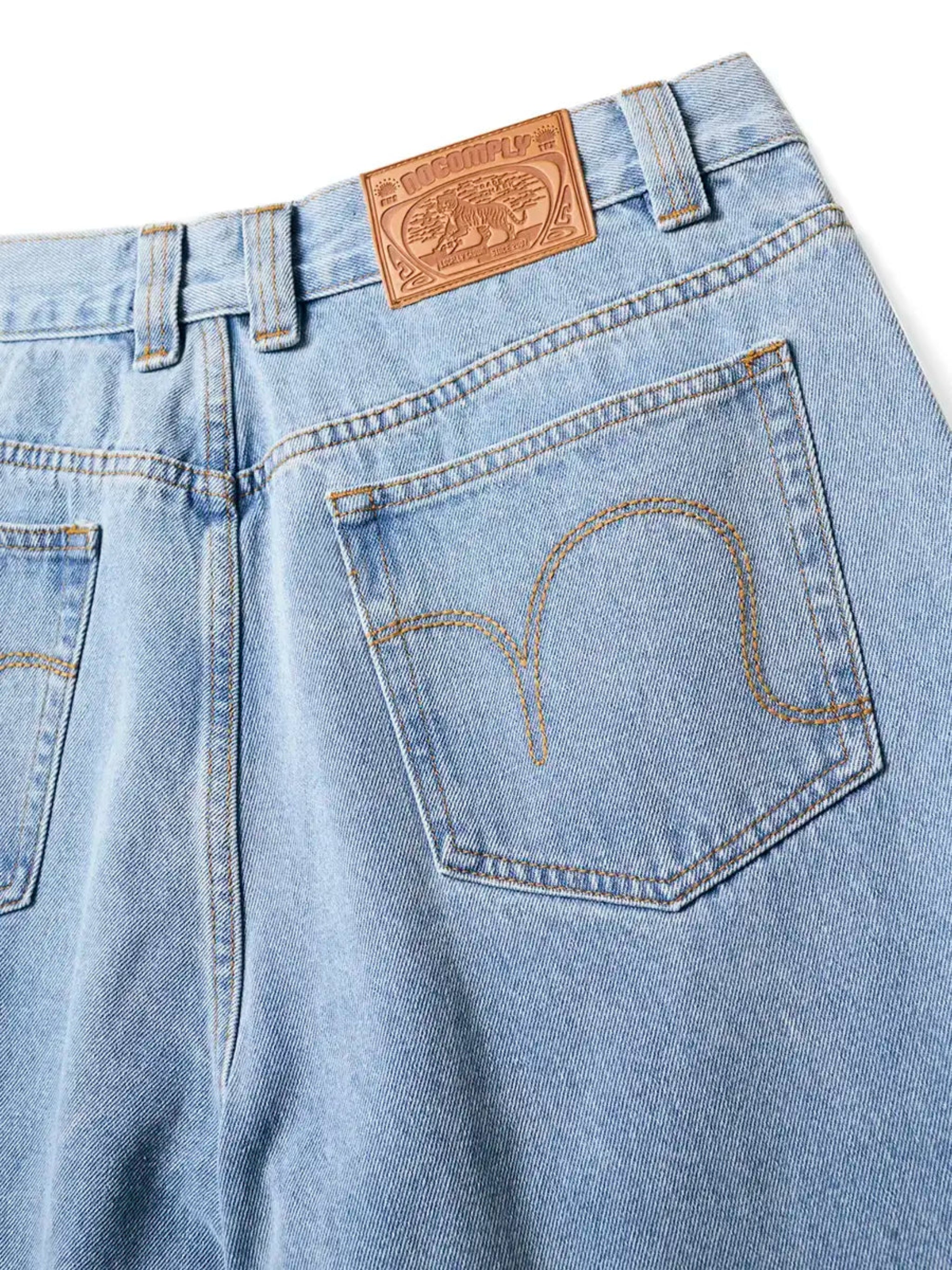 Close up back view of Light Wash No-Comply Loose Fit denim jeans on a white background