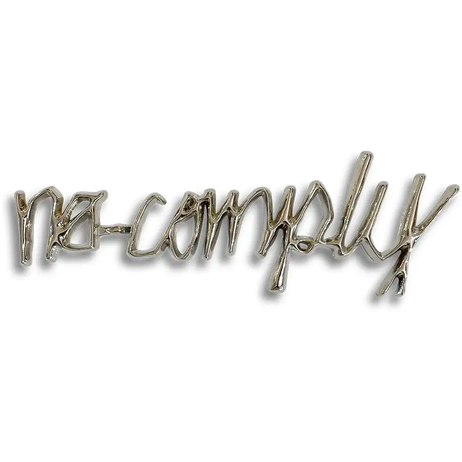 Silver No-Comply Script font logo car emblem, available exclusively at No-Comply Skate Shop in Austin, TX
