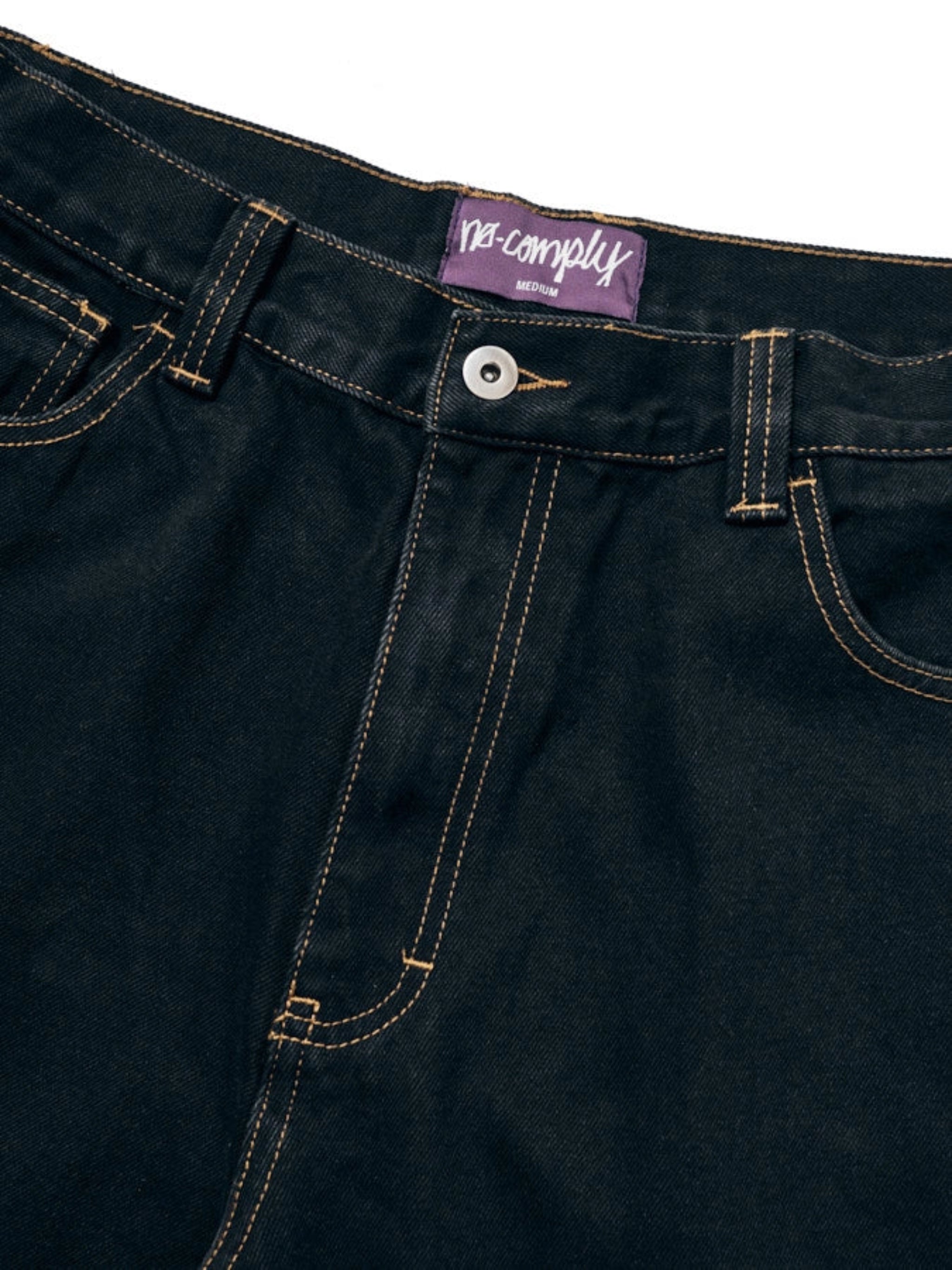 Close up front view of Black No-Comply Loose Fit denim jeans on a white background