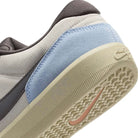 Close-up of Nike SB Force 58 shoe's heel, showcasing gray and blue accents with durable cupsole design.