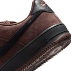 Close up Chocolate Brown suede Nike SB Air Force One skateboard sneaker with black sole and black swoosh branding on a white background