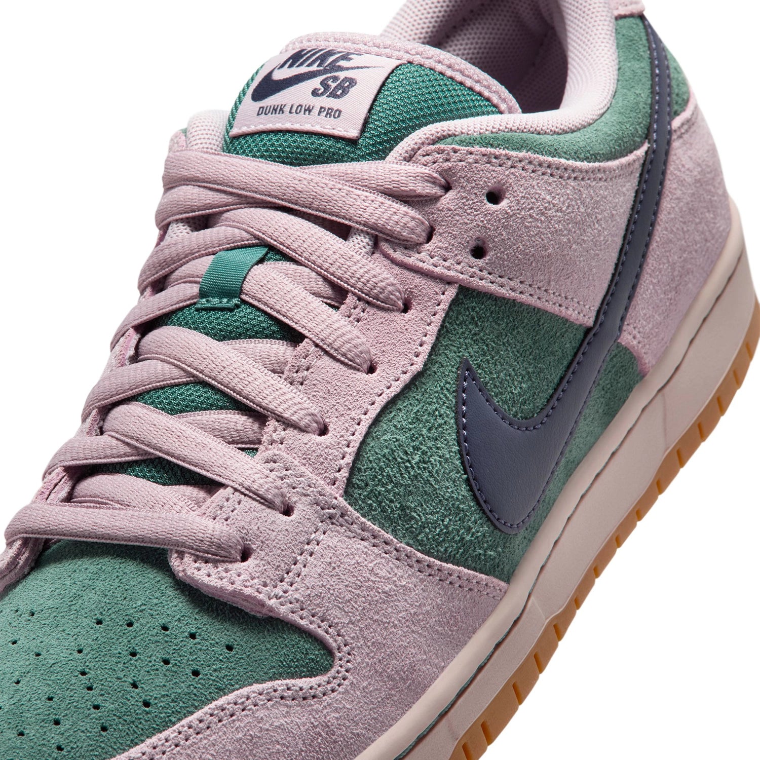 Close up of Green and Pink Nike SB Dunk Low skateboard sneaker on white background