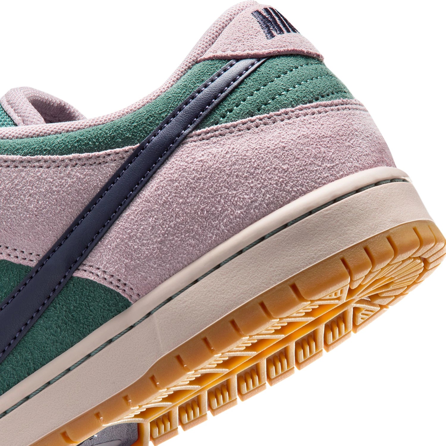 Close up of Green and Pink Nike SB Dunk Low skateboard sneaker on white background