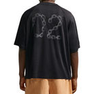Person wearing a black Nike SB Jacquard Skate Jersey with chain graphic on a white background