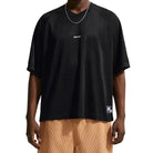 Person wearing a black Nike SB Jacquard Skate Jersey with visible branding on a white background