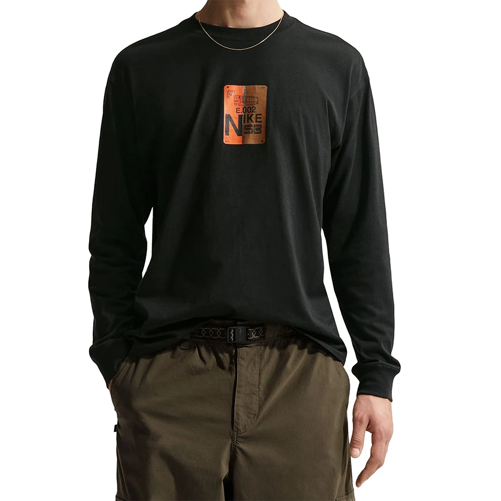 Person wearing a Nike SB Muni-Pass black long-sleeve shirt with a logo on the chest against a white background