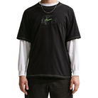 Black Nike SB Ishod Wair athletic t-shirt with a logo worn over a white long-sleeve shirt on a white background