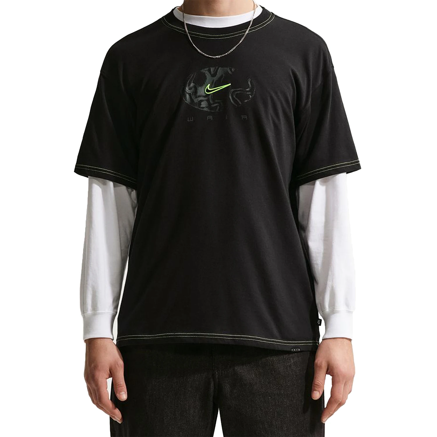 Black Nike SB Ishod Wair athletic t-shirt with a logo worn over a white long-sleeve shirt on a white background