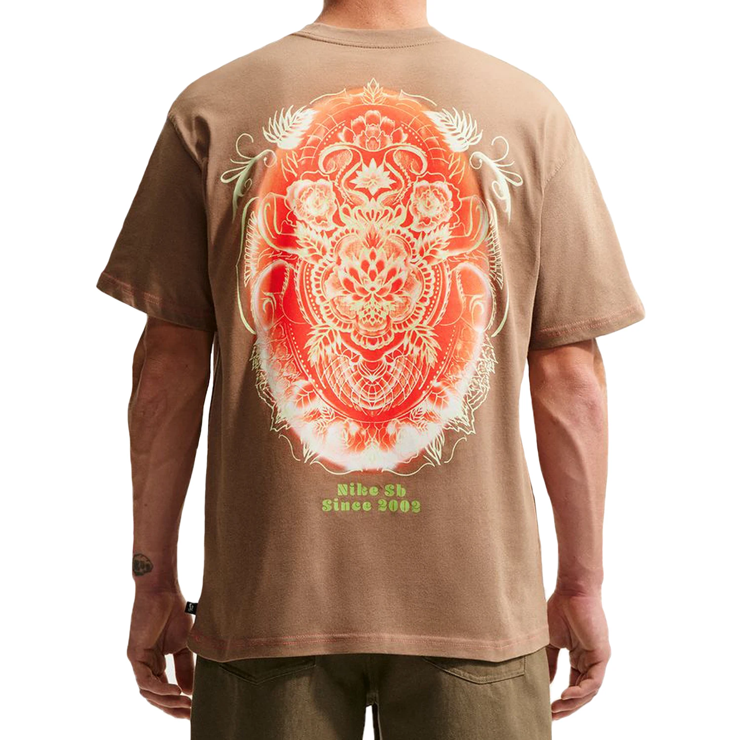A model wearing Driftwood Nike SB Thai New Year men's skate t-shirt with printed back graphic
