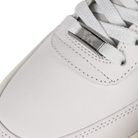 Toe box of White leather and mesh Nike SB x Yuto Horigome Air Force 1 skateboard sneaker with iron grey swoosh and family crest on a white background