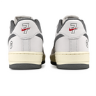 Heel bellows of White leather and mesh Nike SB x Yuto Horigome Air Force 1 skateboard sneaker with iron grey swoosh and family crest on a white background