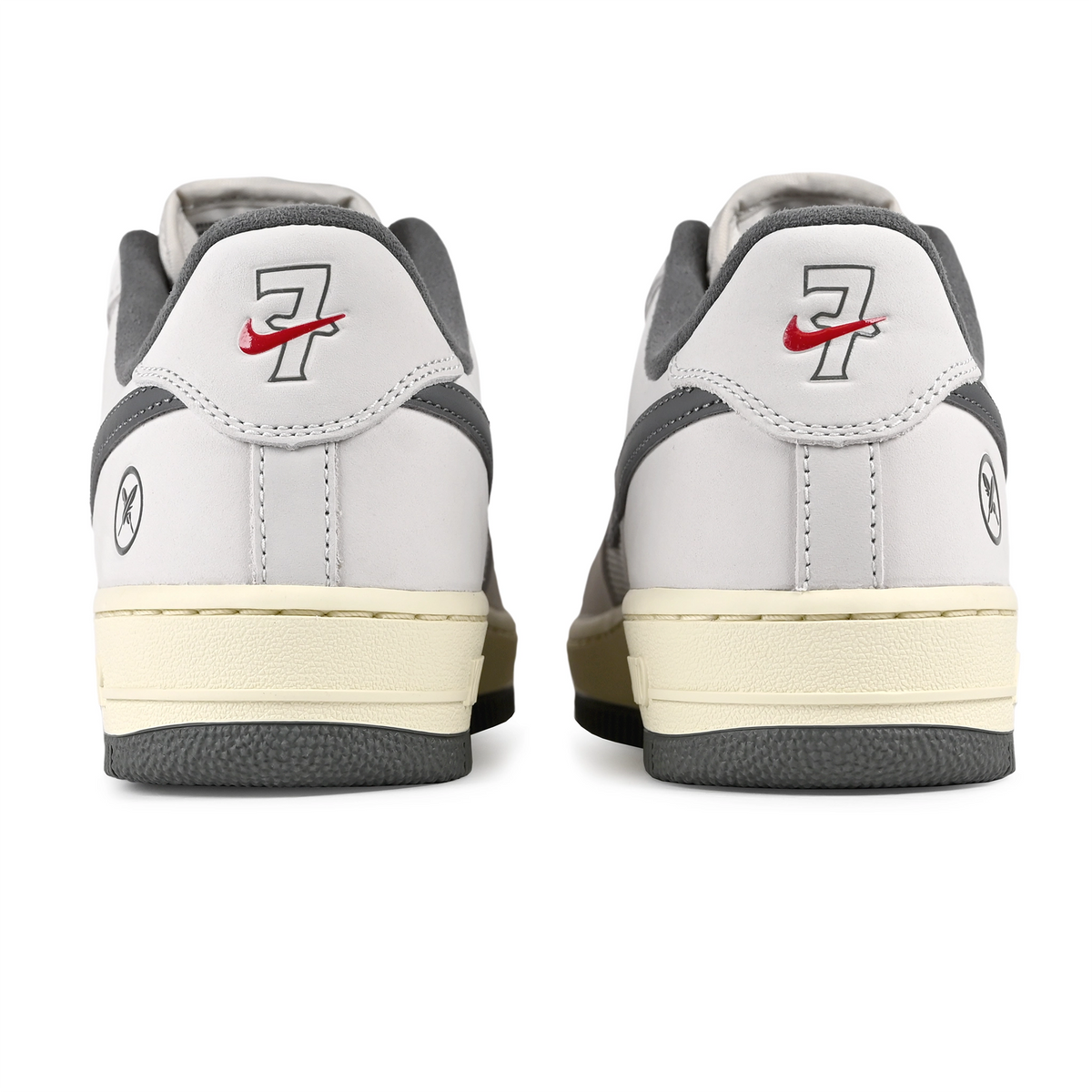 Heel bellows of White leather and mesh Nike SB x Yuto Horigome Air Force 1 skateboard sneaker with iron grey swoosh and family crest on a white background