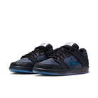 A pair of Black and marina Nike SB Dunk Low Pro men's skateboarding sneakers on a white background 