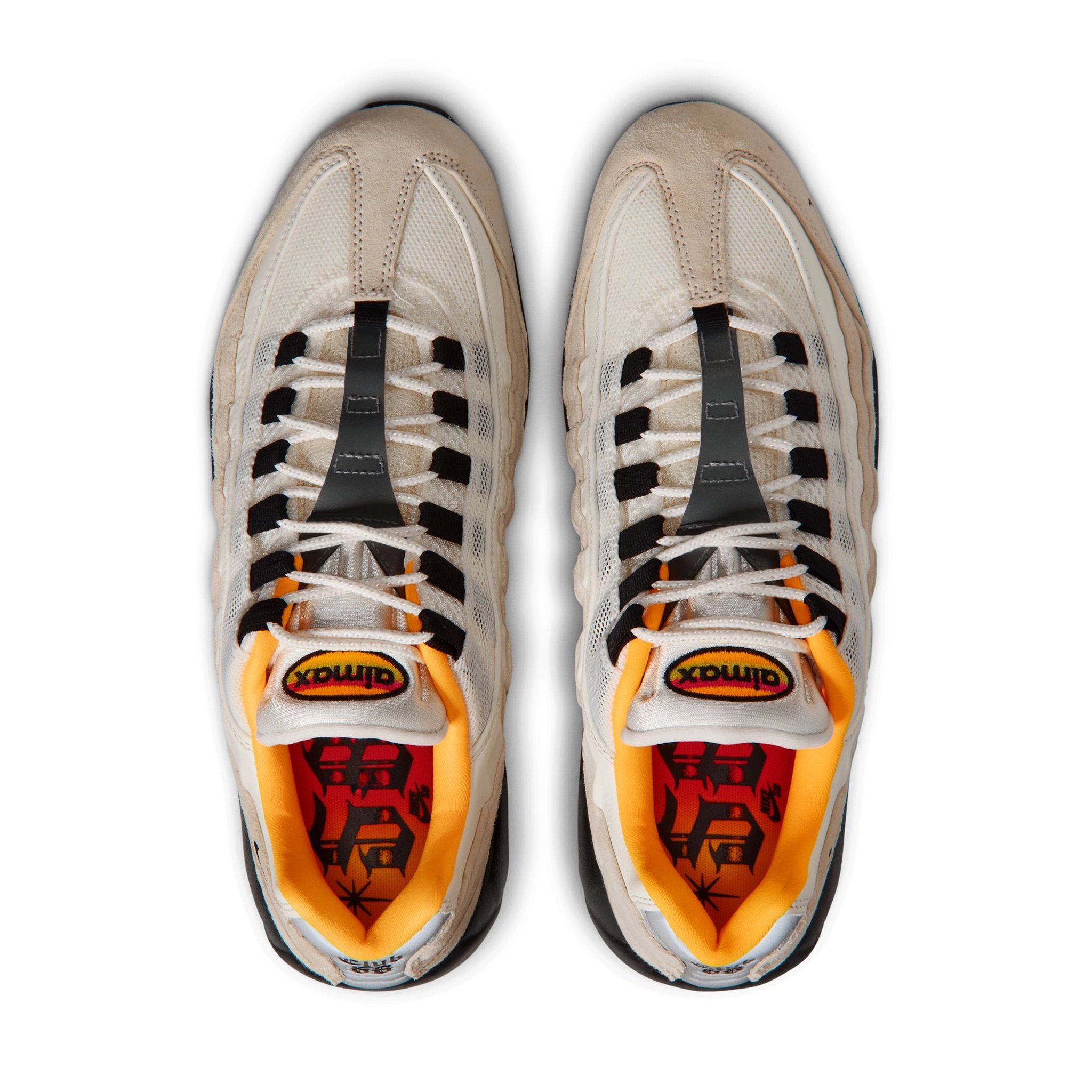 A pair of Sail white Nike SB 'Club 58' Air Max 95 skateboard sneakers with laser orange accents and black sole shown from the top on a white background