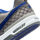 Close up of Flint grey Nike SB Paul Rodriguez Zoom Air skateboard sneaker with royal navy swoosh on a white background