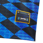 Woven patch on a Blue and black checkered adidas Skateboarding x Thrasher Magazine x Argentina Football Association  polo jersey on a white background