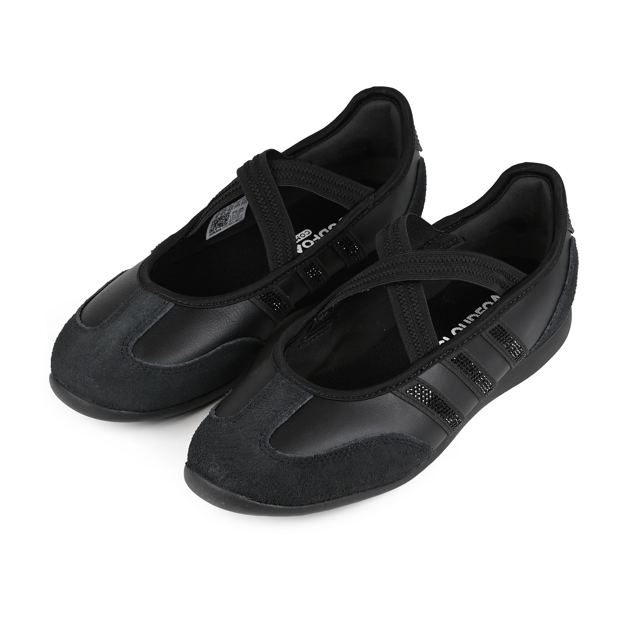 A pair of core black Adidas Originals Mary Jane sneakers with textured leather and suede panels, three rhinestone-embellished stripes, and a black elastic strap across the instep on a white background.