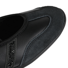 Toe box of a core black Adidas Originals Mary Jane sneaker with textured leather and suede panels, three rhinestone-embellished stripes on a white background.
