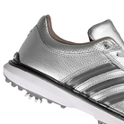 A close up of silver metallic Adidas x Metalwood MC70 golf shoe with gray stripes on a white background