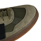 Toe box of Olive Strata adidas Skateboarding Mark Gonzales pro model Aloha Super skateboard sneaker with core black stripes on a white background