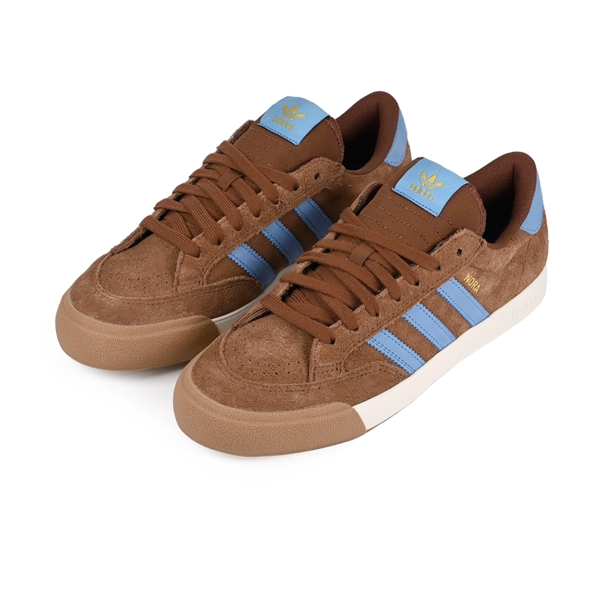 A pair of Gum brown adidas Skateboarding Nora Vasconcellos skateboard sneakers with blue stripes on a white background