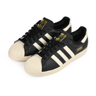 A pair of Core black adidas Skateboarding Superstar 80 ADV skateboard sneakers on a white background