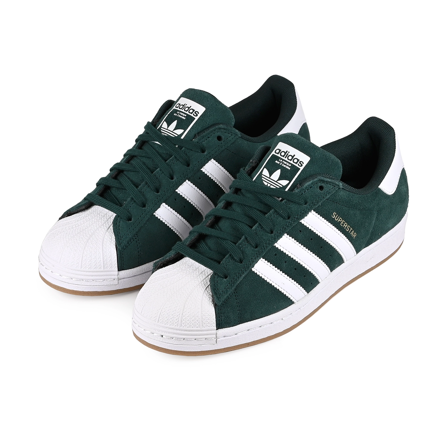 A pair of Aurora Ivy and white Adidas Skateboarding Superstar ADV men's skateboard sneakers on a white background