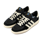 A pair of Core black and cream white adidas Skateboarding x Thrasher Magazine x Argentina Football Association Glenburn skateboard sneakers on a white background