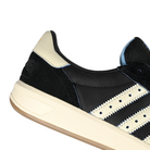 Close up of Core black and cream white adidas Skateboarding x Thrasher Magazine x Argentina Football Association Glenburn skateboard sneaker on a white background