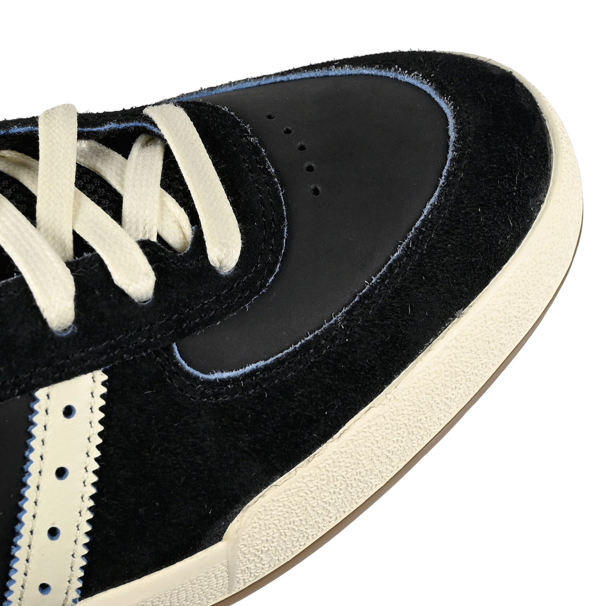 Toe box of Core black and cream white adidas Skateboarding x Thrasher Magazine x Argentina Football Association Glenburn skateboard sneaker on a white background