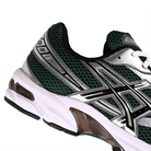 Close up of Evergreen and silver Asics GEL-1130 Sportstyle sneaker with Onitsuka branding on a white background